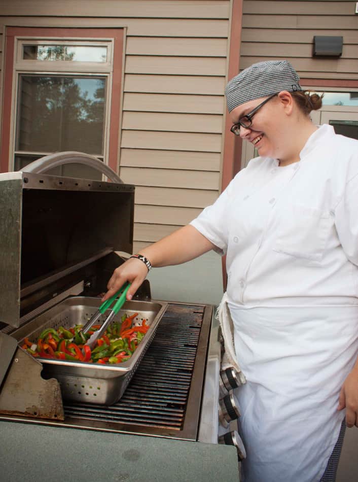 A chef at the Pines Senior Living grilling food for the residents