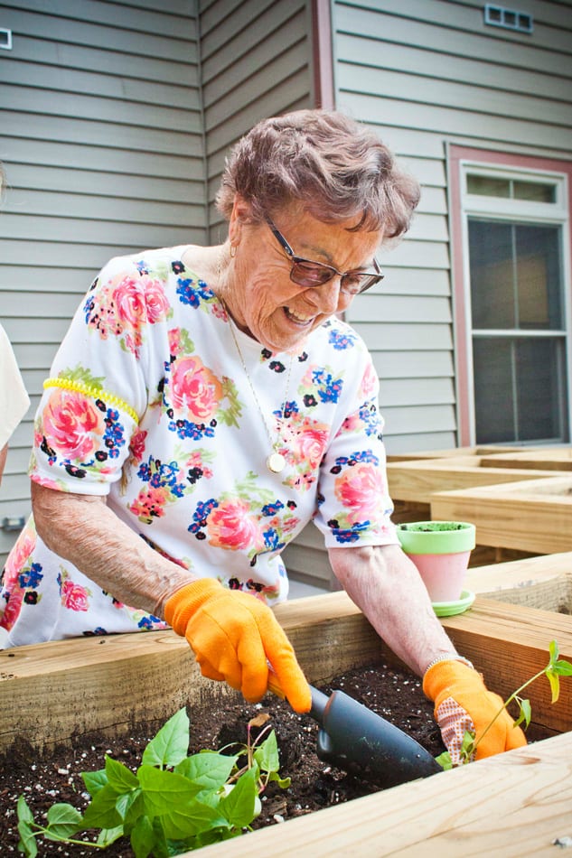 Mrs Miller Gardening A Pines Senior Living resident gardening outside